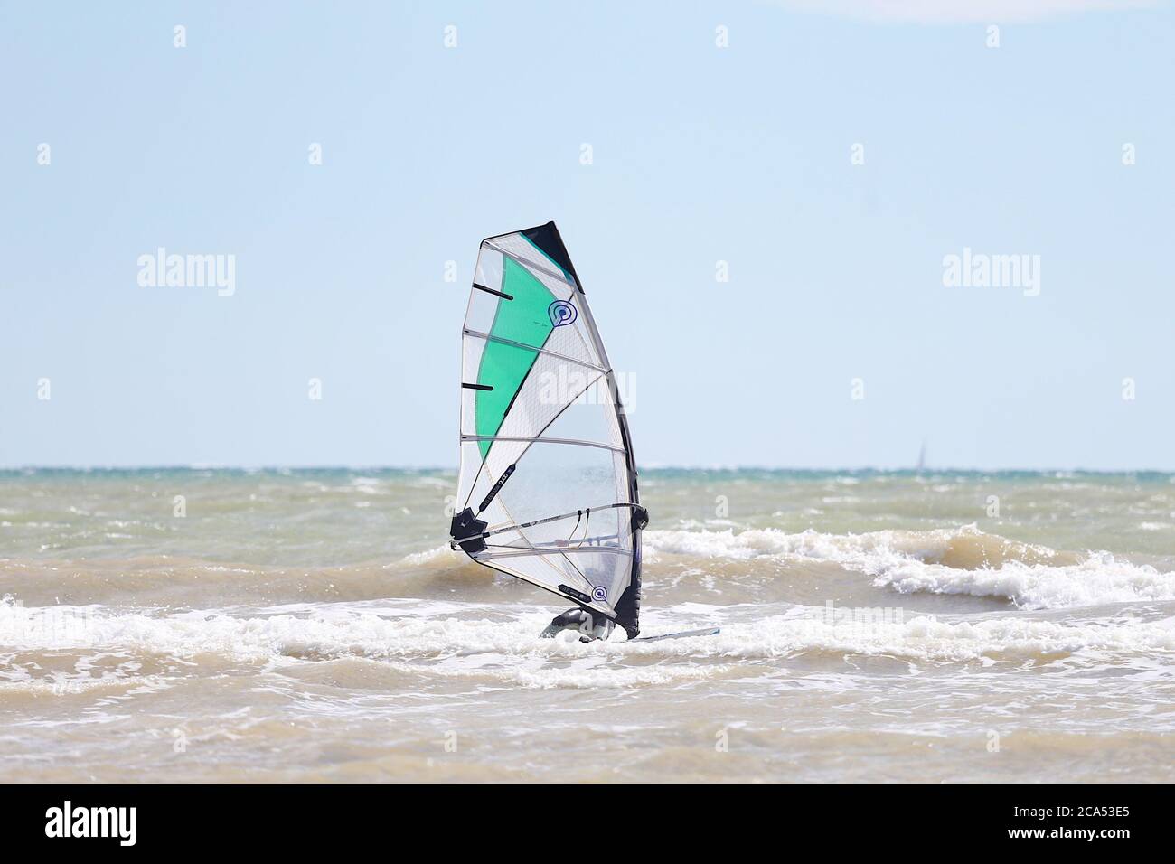 Camber, East Sussex, UK. 04 Aug, 2020. UK Weather: The wind has picked up which is Ideal for these kite surfers who take advantage of the blustery conditions before the predicted heatwave in the coming days. Photo Credit: Paul Lawrenson-PAL Media/Alamy Live News Stock Photo
