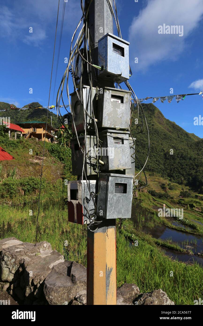 Electric meter boxes on a pole in rural Philippines. Electricity meters
