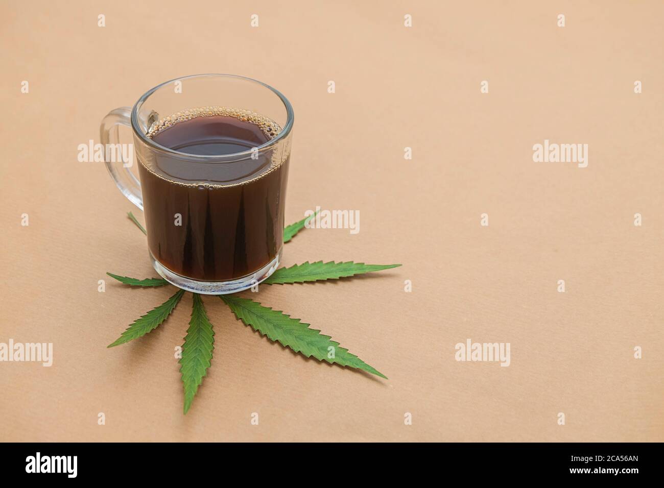 CBD infused coffee on neutral beige background. Alternative medicine concept. Copy space Stock Photo