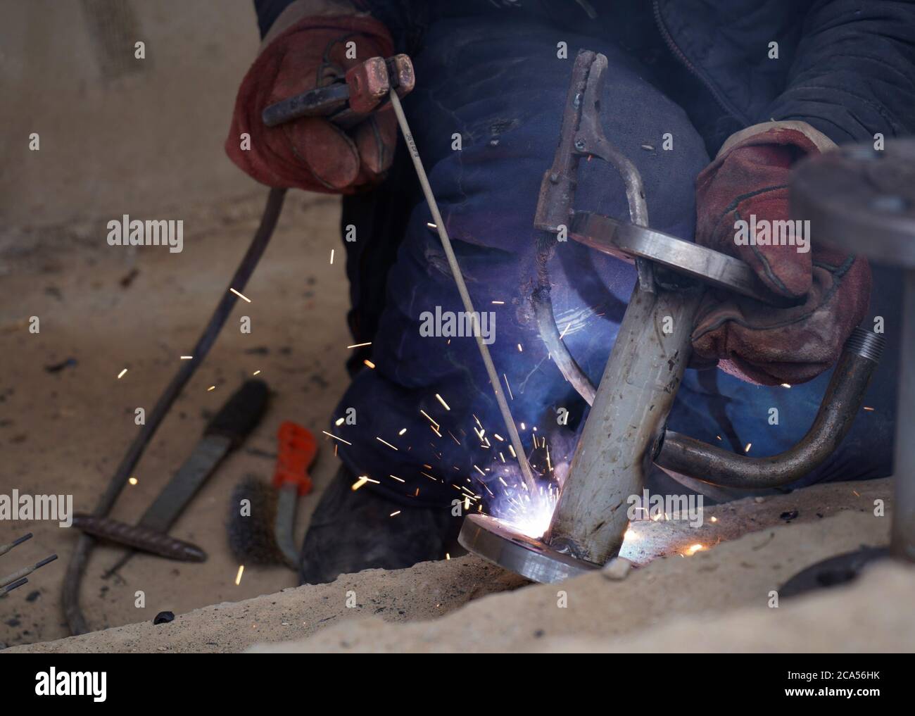 Closeup welder working with electrode at semiautomatic arc welding in