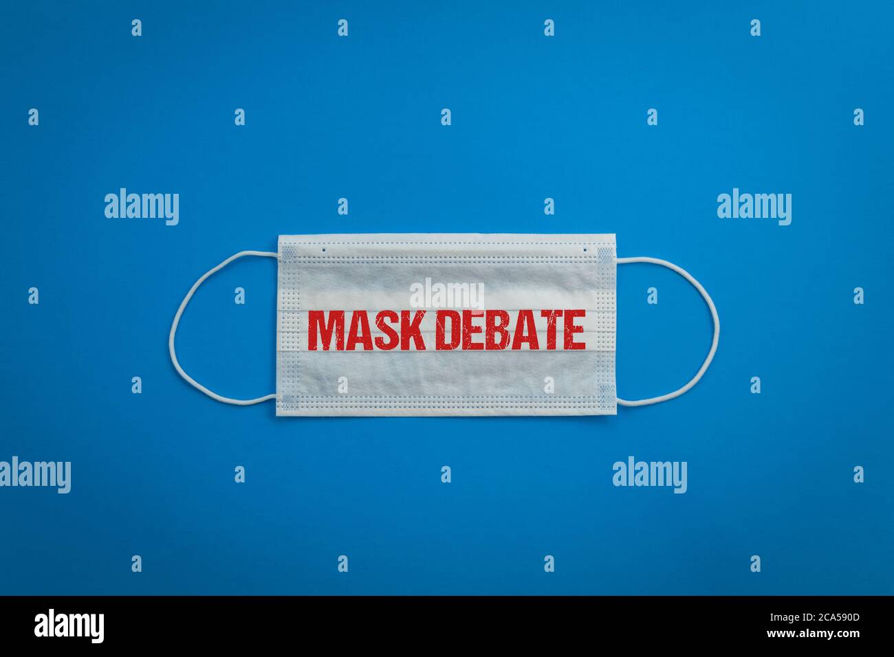 Mask on blue background MASK DEBATE red text copy space.  Funny pun on words sound like something else. Stock Photo