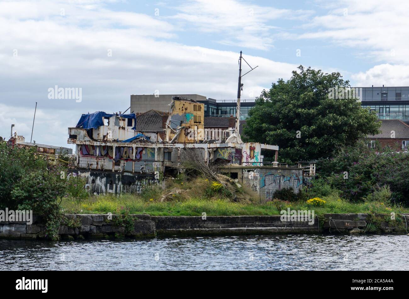 The rusting hulk of the Naomh Eanna, a former ferryboat lying in dry dock in the Grand Canal Lock in Dublin, Ireland. There are plans to refurbish it. Stock Photo