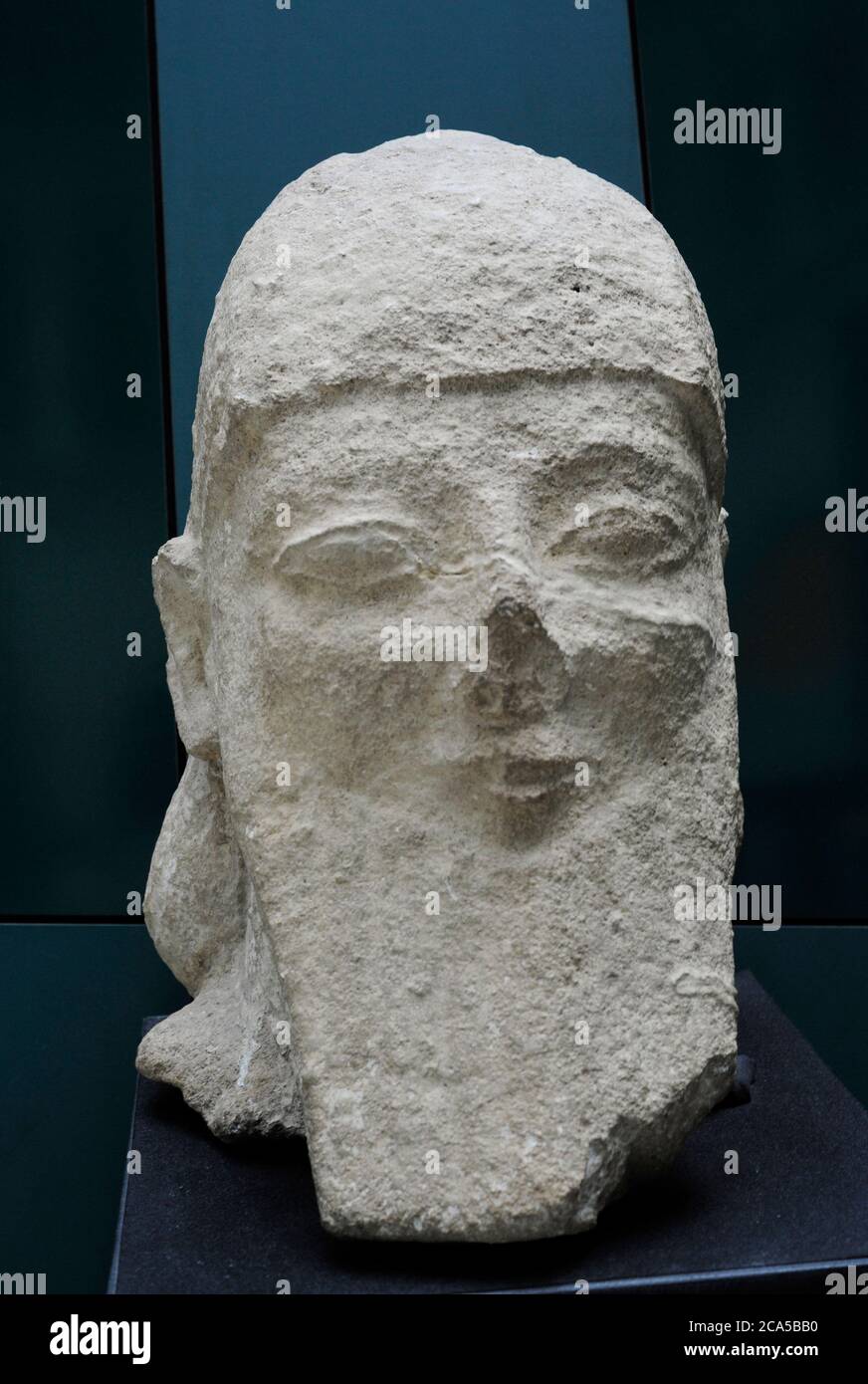Colossal male head with square beard in Assyrian fashion, wearing pointed helmet. Limestone. 560-540 BC. From Kition, Cyprus. Museum of the Mediterranean and Near Eastern Antiquities. Stockholm, Sweden. Stock Photo