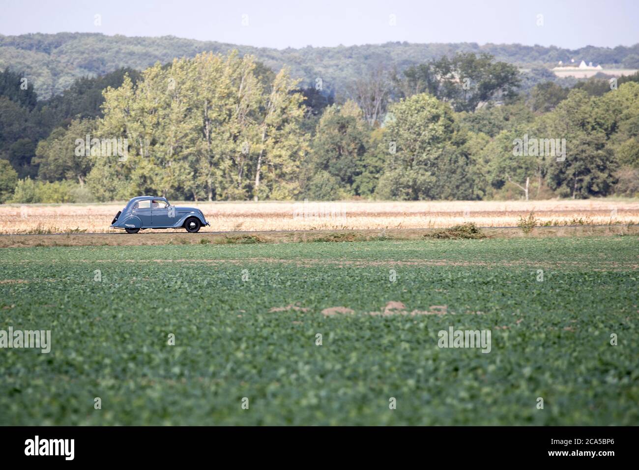 France, Loir et Cher, Loire valley listed as World Heritage by UNESCO, Couture-sur-Loir, Peugeot 201 driving on the road Stock Photo