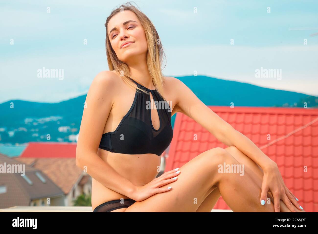 Beautiful tanned woman portrait at resort with beautiful view Stock Photo
