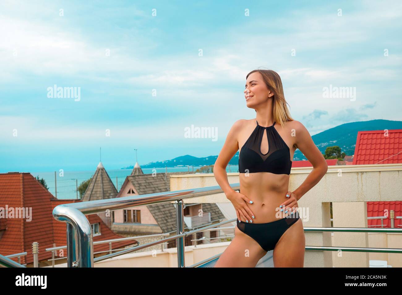 Beautiful tanned woman portrait at resort with beautiful view Stock Photo