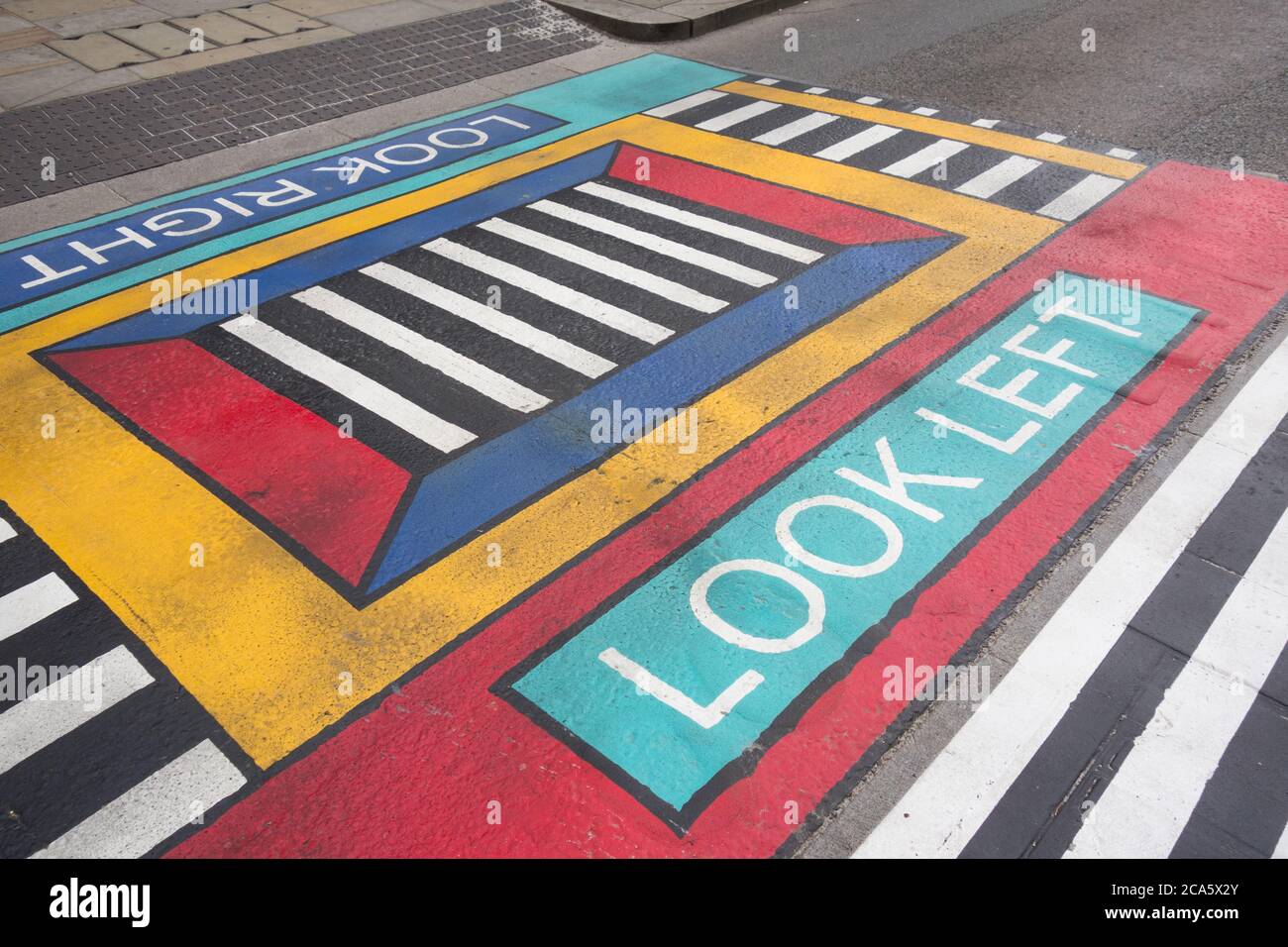 Closeup of French artist Camille Walala's geometric pedestrian crossings outside White City underground station in west London, UK Stock Photo