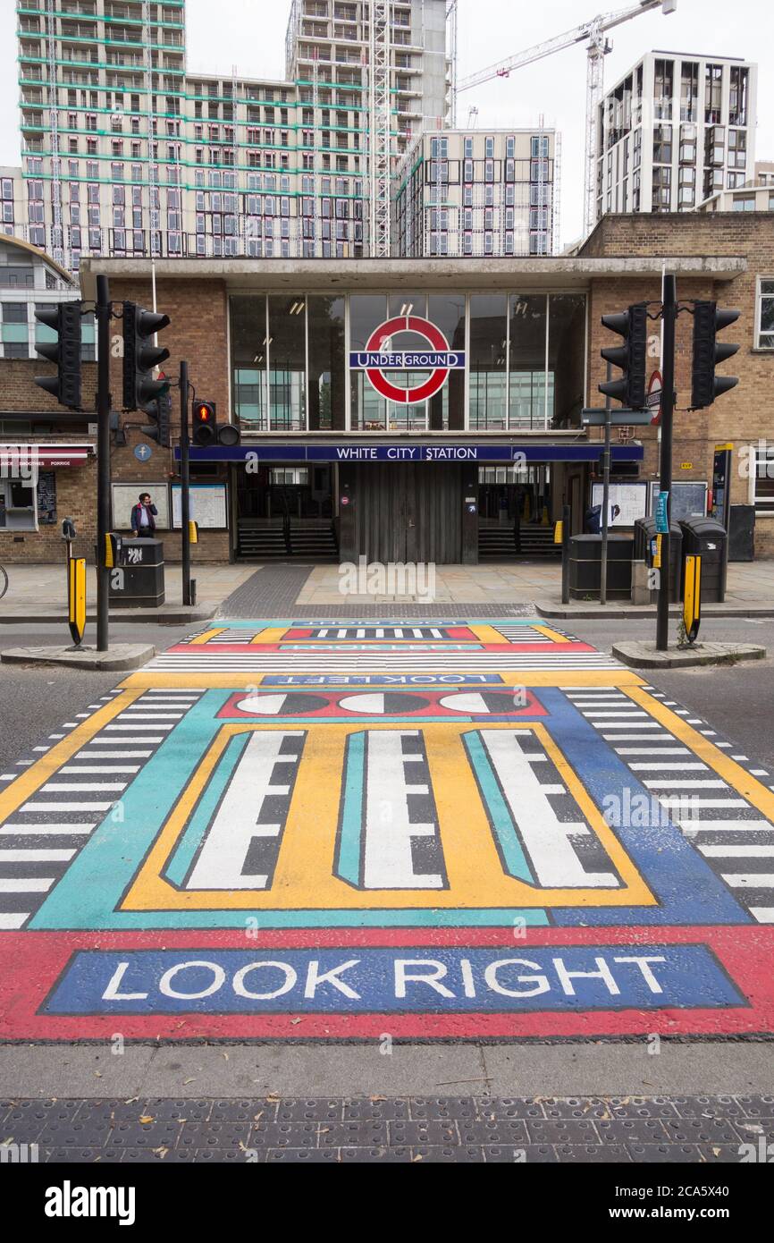 French artist Camille Walala's geometric pedestrian crossings outside the entrance to White City underground station in west London, UK Stock Photo