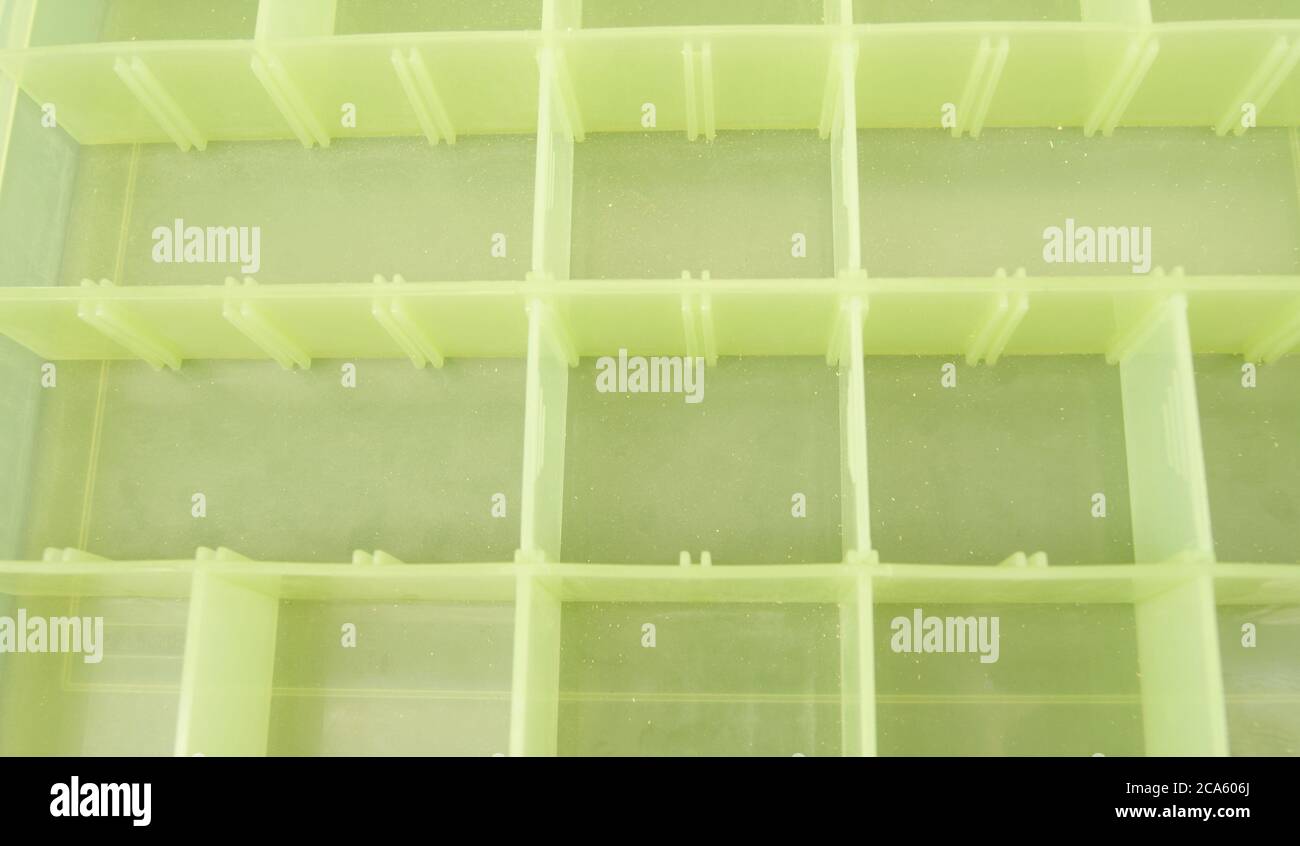 Green plastic box, with several divisions for placing material, texture or canvas background Stock Photo