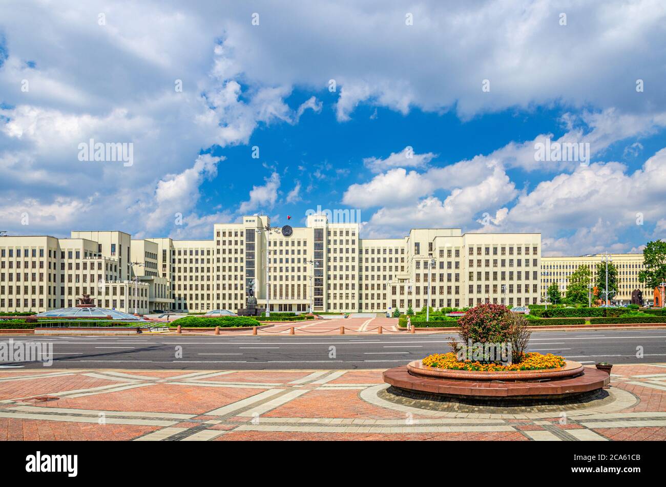 The Government House constructivism style building and Vladimir Lenin statue on Independence Square in Minsk city historical centre, blue sky white clouds in sunny summer day, Republic of Belarus Stock Photo