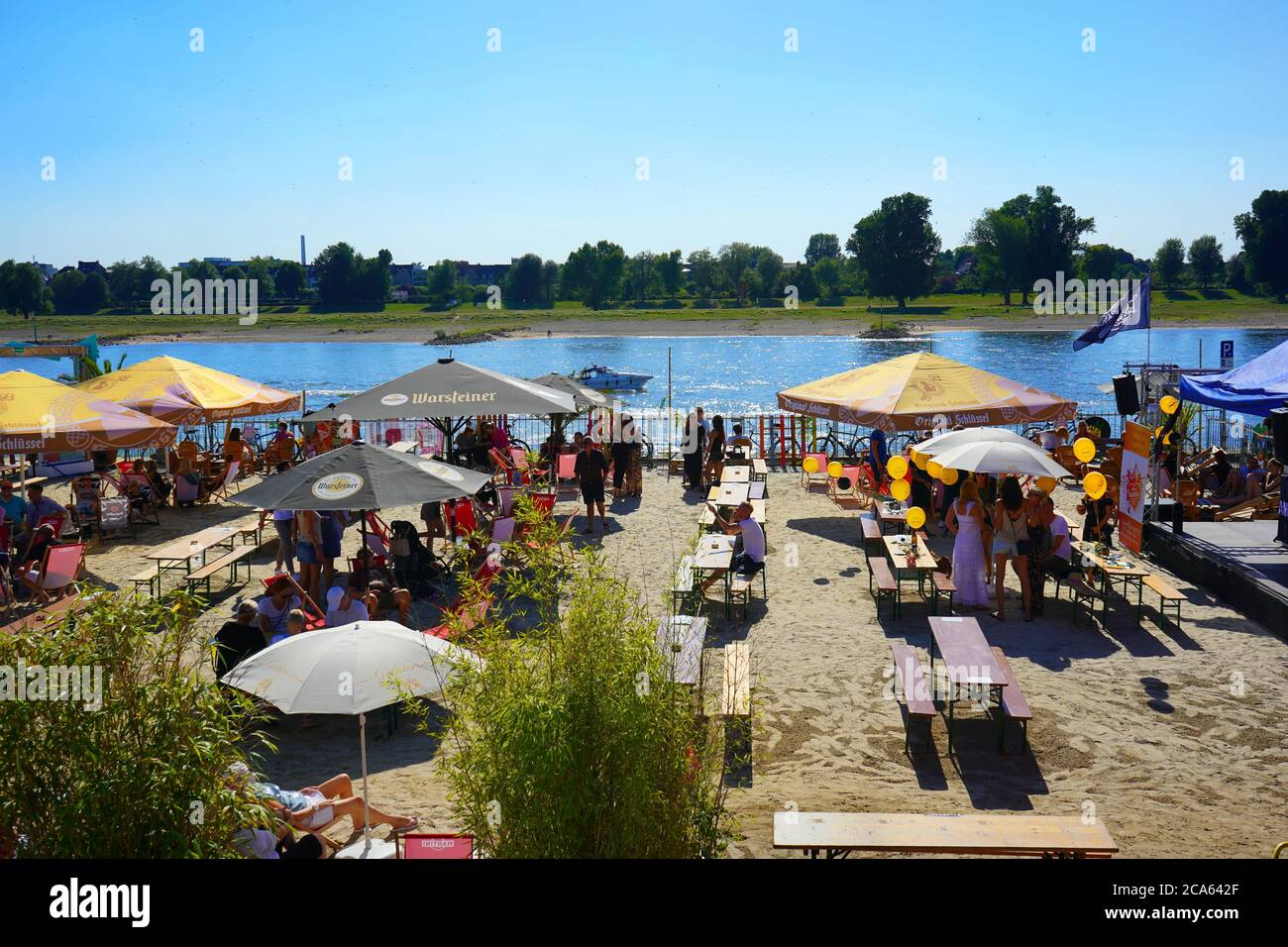 So-called 'Stadtstrand' (city beach) at the Rhine river in Düsseldorf on a beautiful summer day. Stock Photo