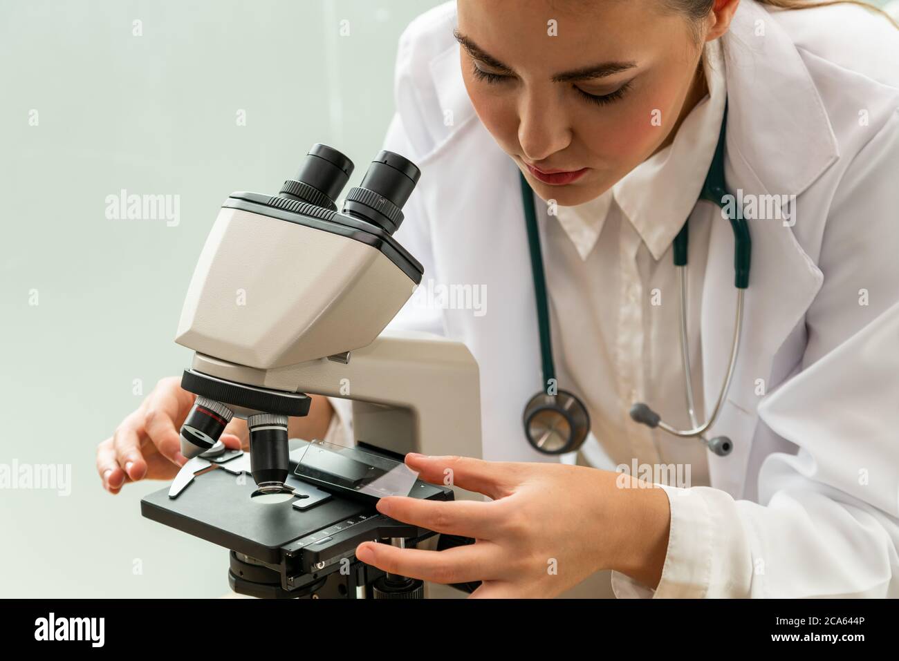 Doctor using microscope in hospital laboratory Stock Photo Alamy