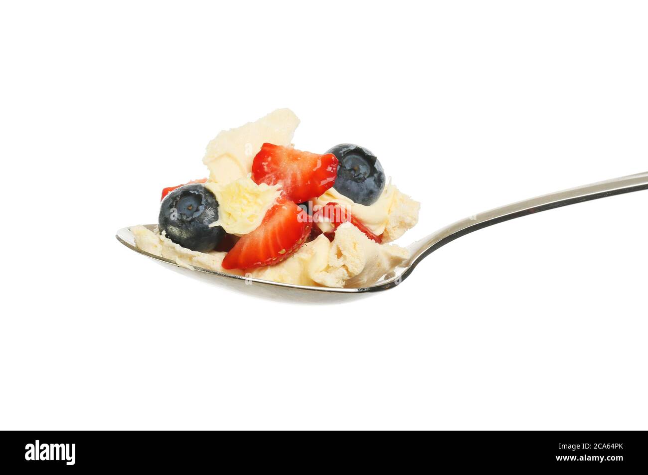Strawberries, blueberries, meringue and clotted cream in a spoon