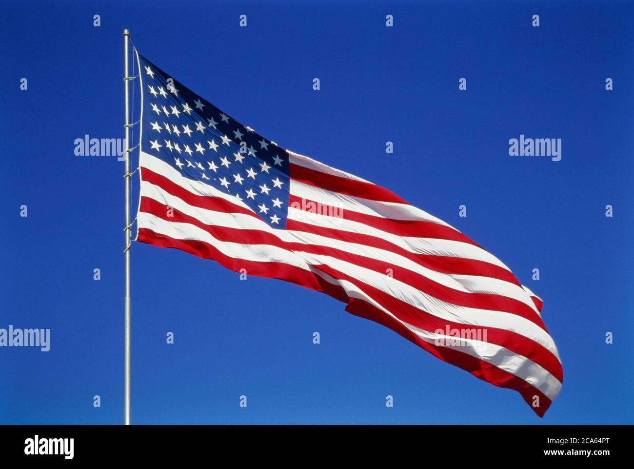 View of American Flag blowing in wind Stock Photo