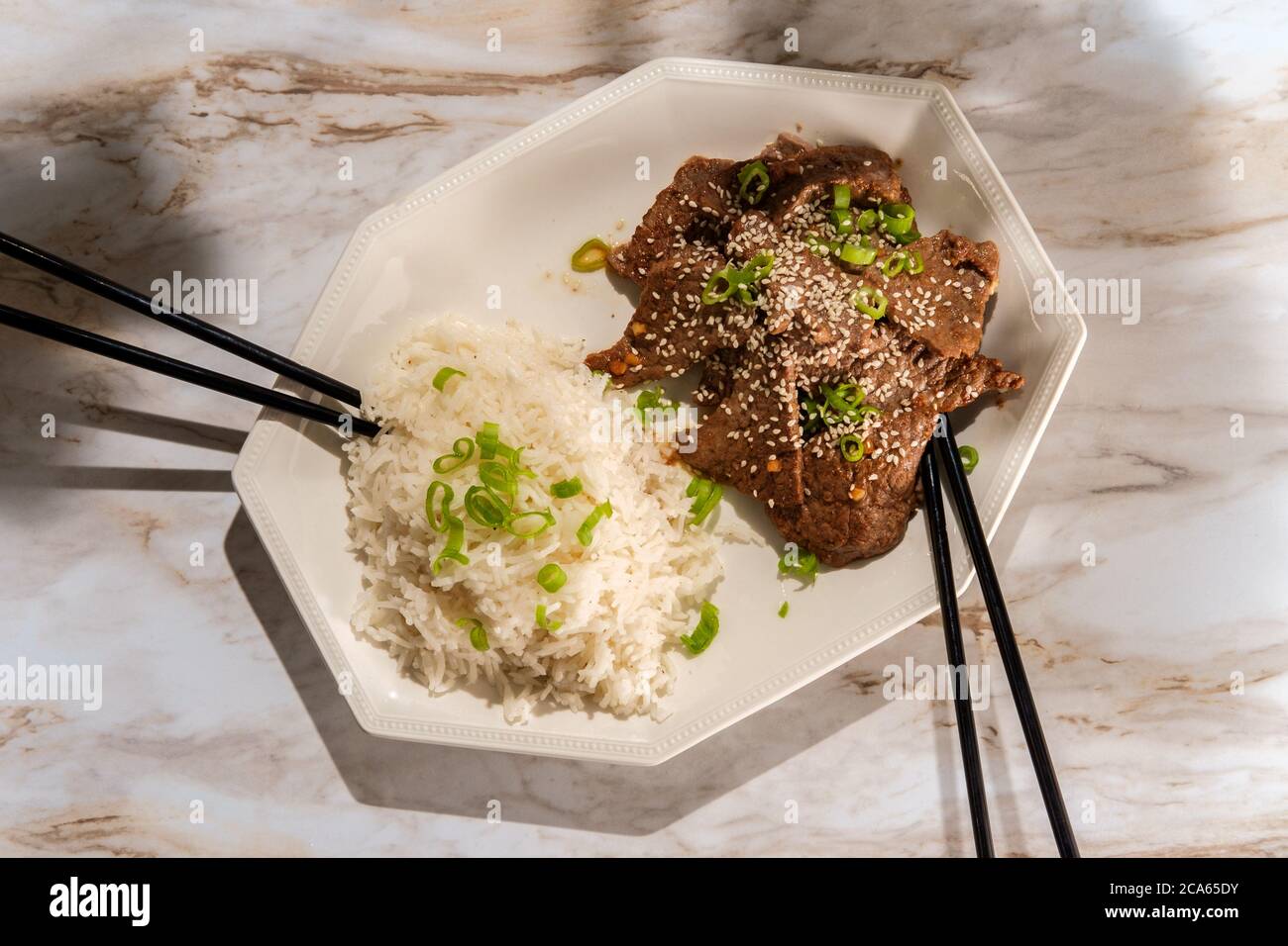 Vietnamese pan grilled sesame seed beef with side of white rice Stock Photo