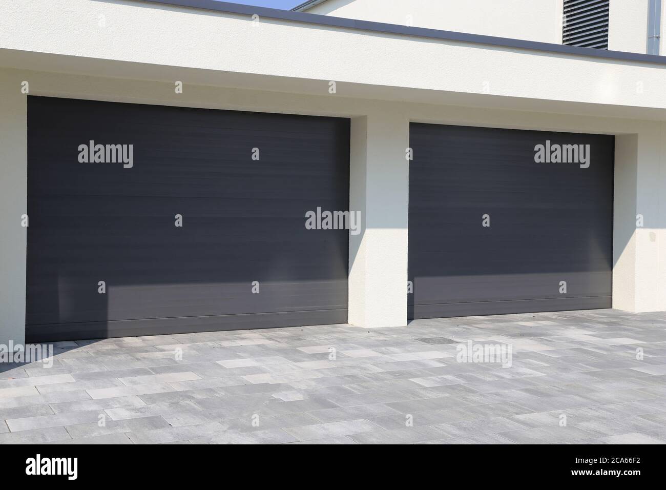 Two modern new garage doors (sectional doors) Stock Photo