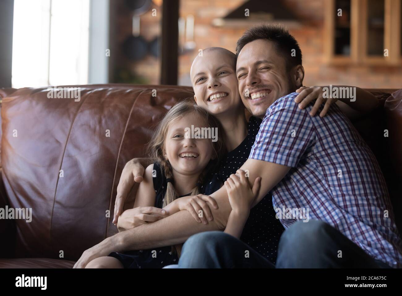 Happy family with sick mom embrace at home Stock Photo