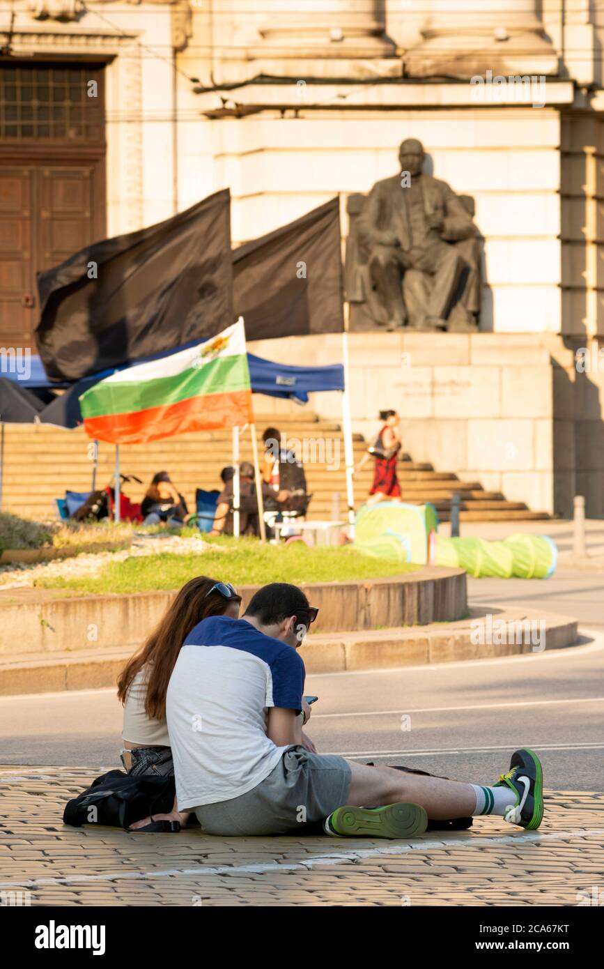 Sofia Bulgaria, Eastern Europe, Balkans, EU, protest, anti-Government peaceful protest, 2020, protestors, closed street. closed streets. empty street, empty streets, peaceful protest, protesting, no transports, closed for transport, election, elections, couple sitting on street Stock Photo