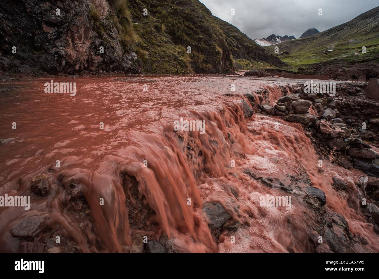 Hasty construction of the road to rainbow mountain in Peru leads to formerly clean rivers choked with sediment and runoff from erosion. Stock Photo