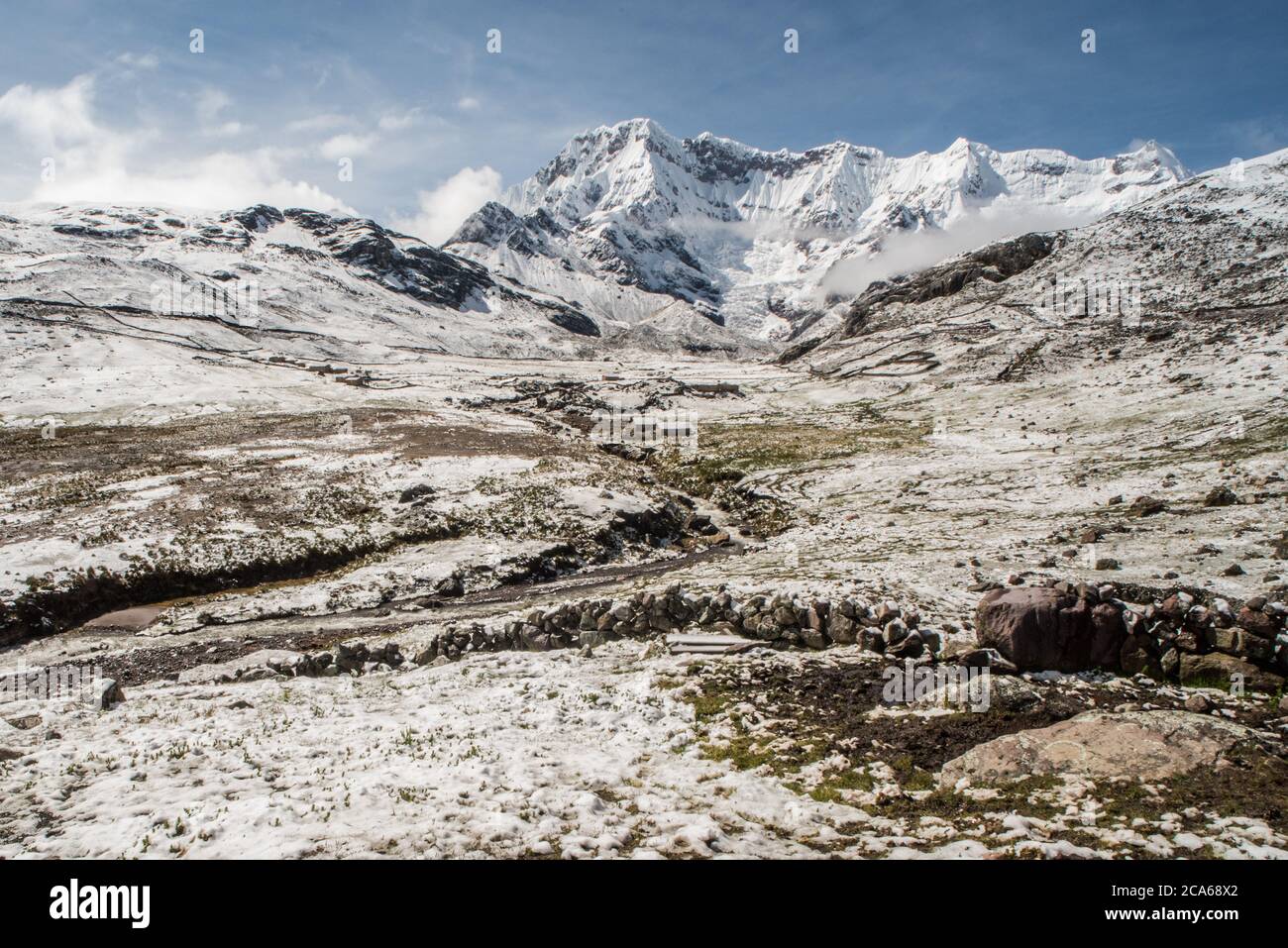A blizzard swept in and morning arrives with the Andean landscape of the Cordillera Vilcanota covered in snow. Stock Photo