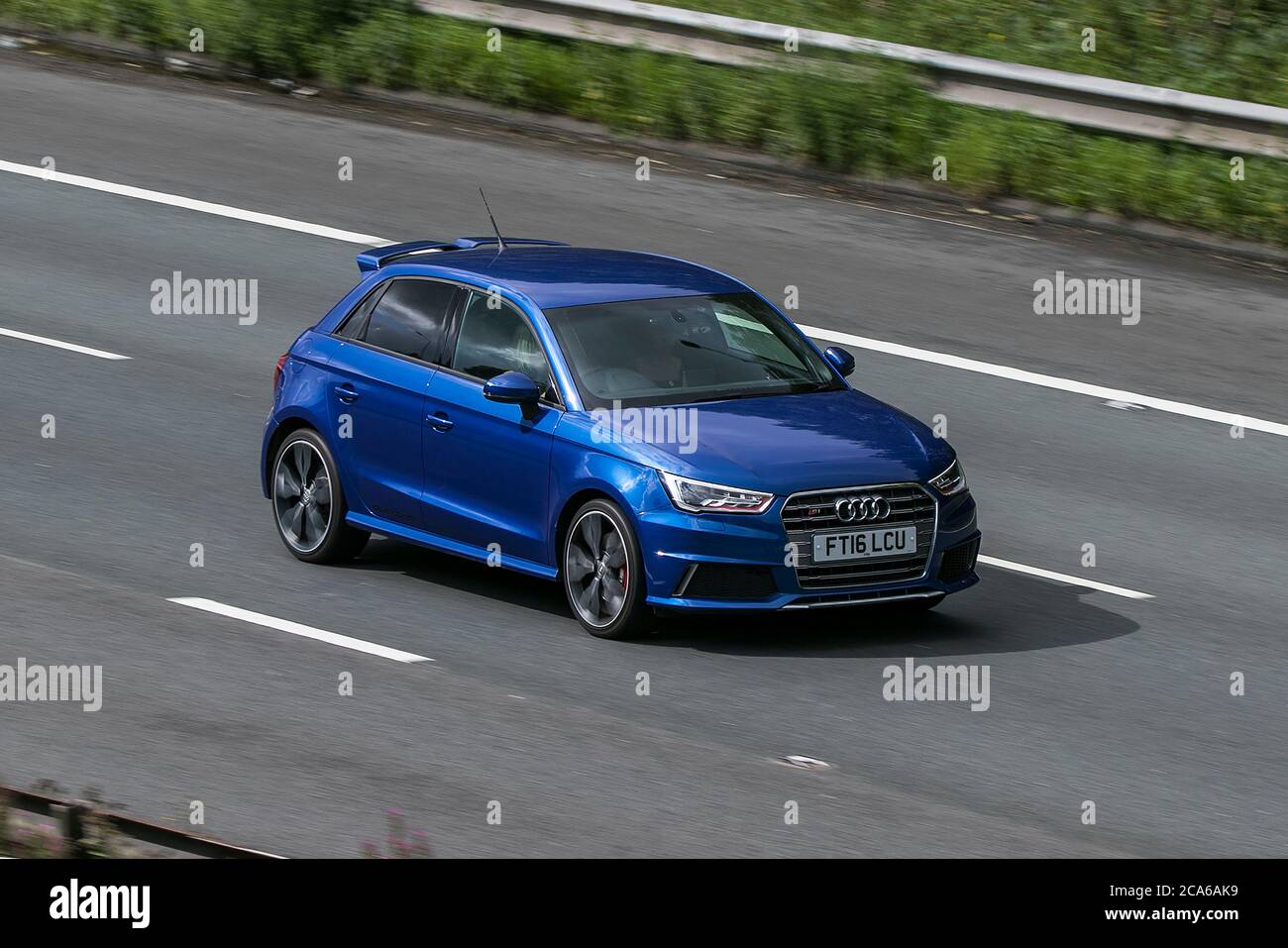 A 2016 Audi S1 Quattro Blue Car Hatchback Petrol driving on the M6 motorway near Preston in Lancashire, UK Stock Photo