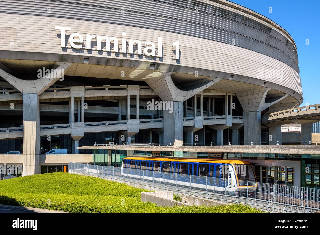 A CDGVAL airport shuttle is stationing at the station at the foot of the Terminal 1 circular concrete building of Paris-Charles de Gaulle Airport. Stock Photo