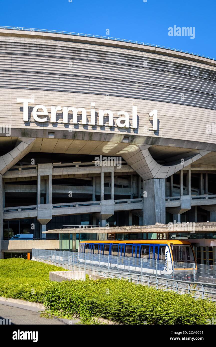 A CDGVAL airport shuttle is stationing at the station at the foot of the Terminal 1 circular concrete building of Paris-Charles de Gaulle Airport. Stock Photo