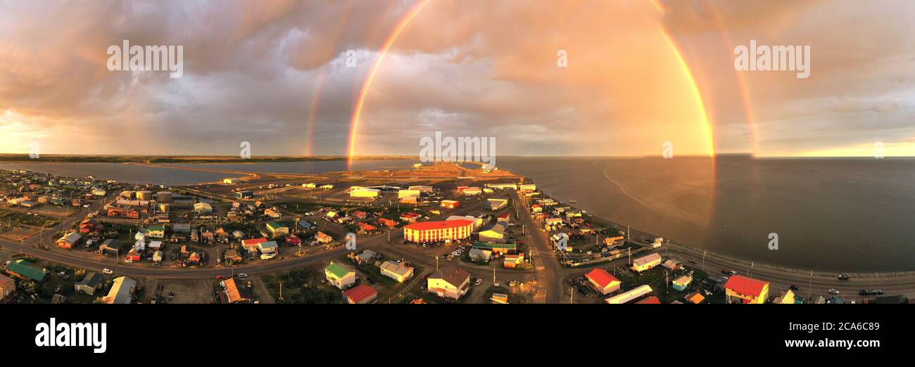 Rain falls as sun shines in the middle of the night at Kotzebue Alaska creating a beautiful contrast between the sunrise and storm Stock Photo