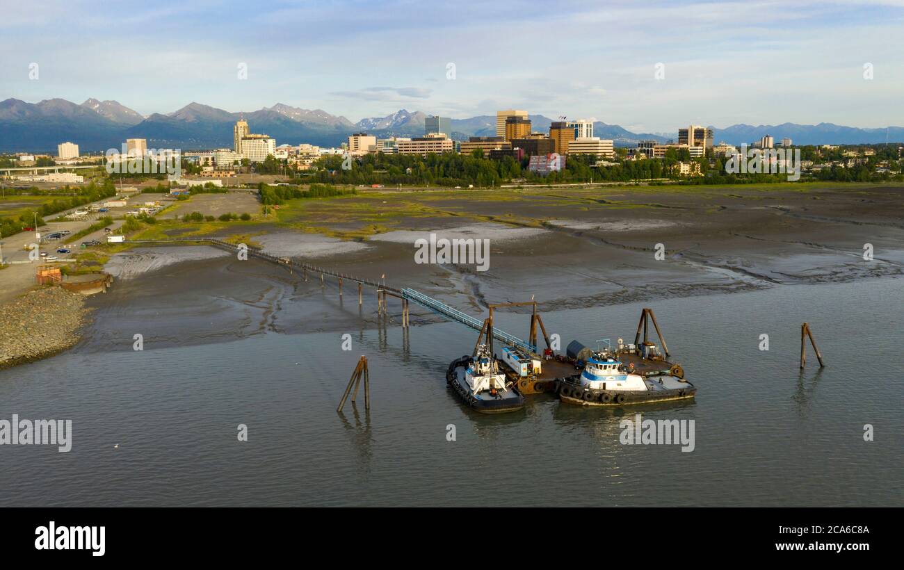 Tug boats are moored at a private dock near Fish Creek in the Coook Inlet Alaska Stock Photo