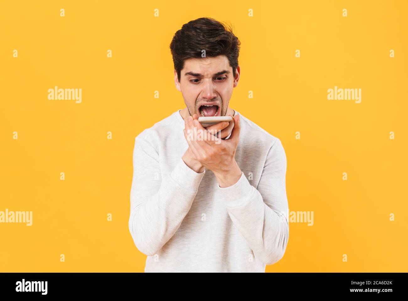 Photo of furious unshaven sick man screaming while talking on