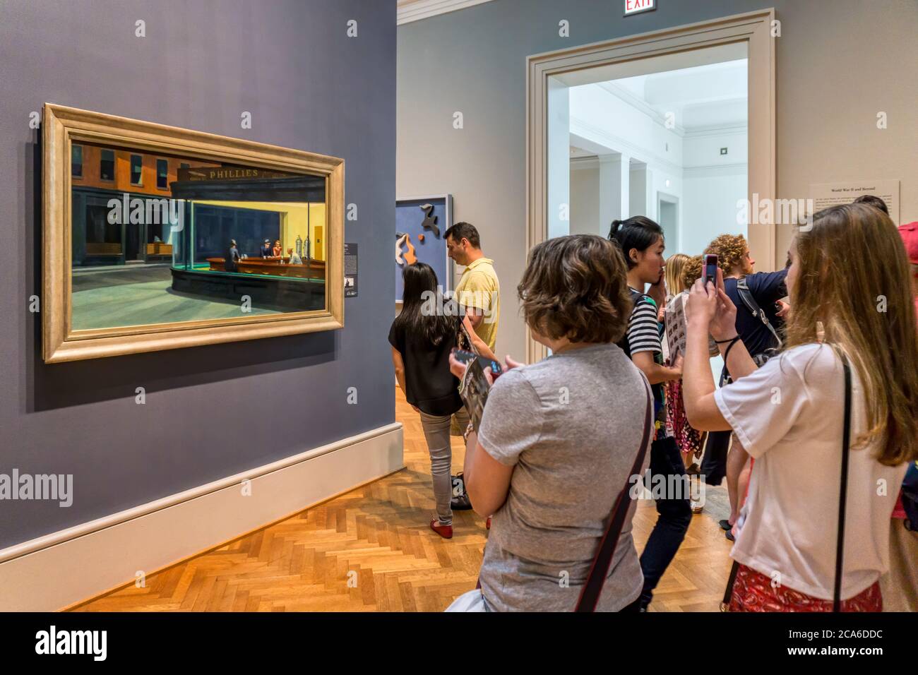 People looking at Nighthawks by Edward Hopper in a gallery at the Art Institute of Chicago. Stock Photo
