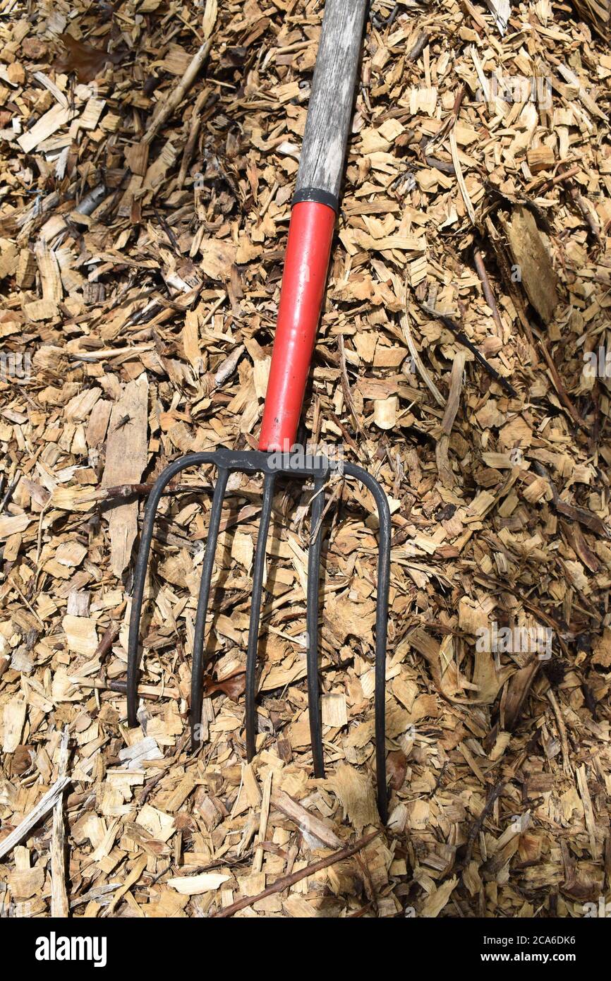 Pitchfork in Mulch Chips Stock Photo Alamy