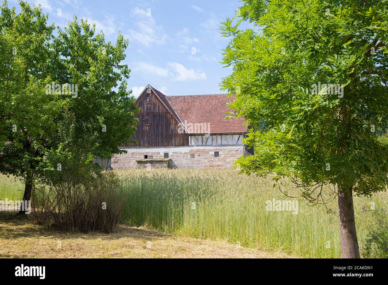 Old farmhouse and trees in rural landscape Stock Photo - Alamy