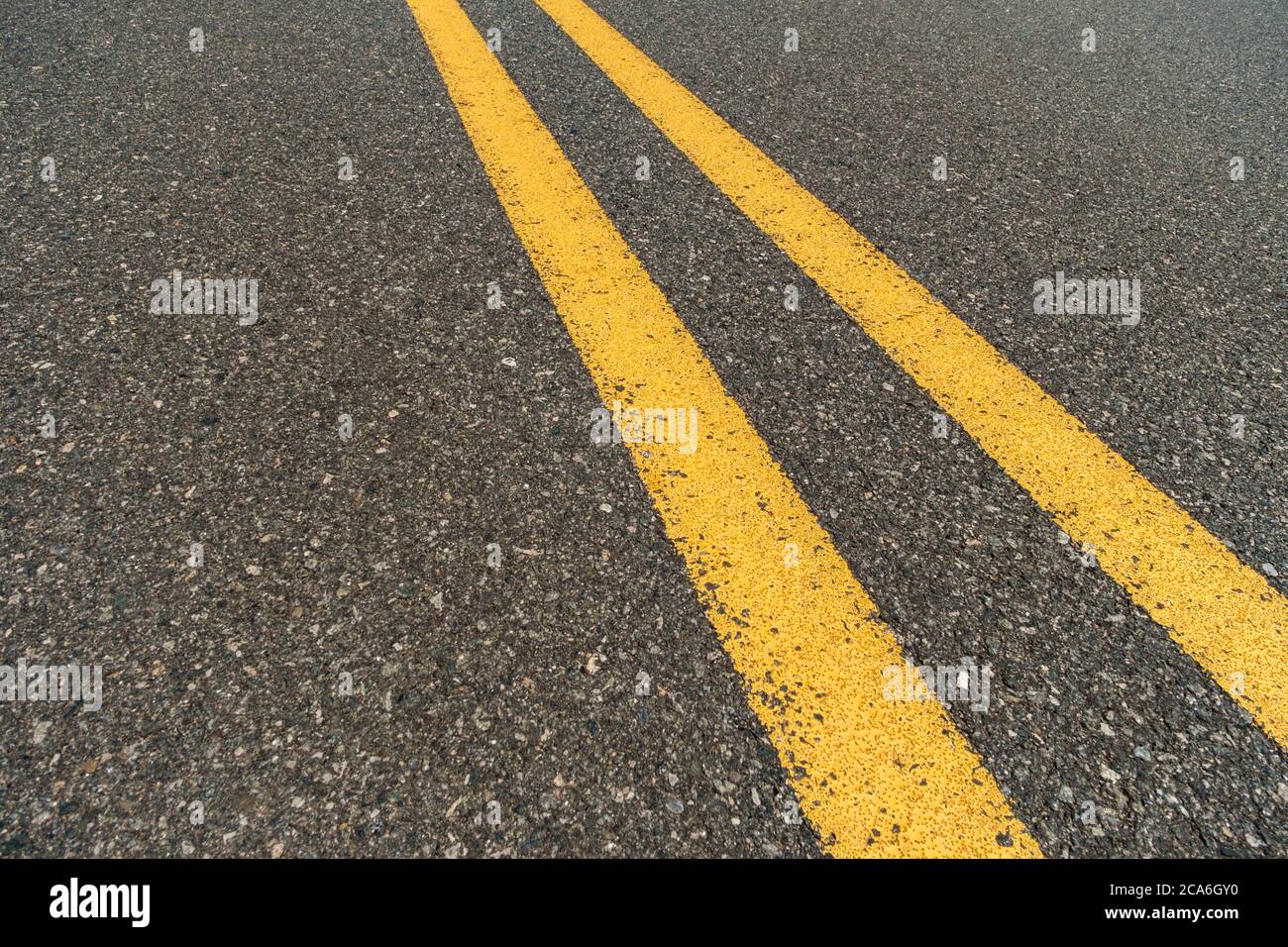 Double yellow lines on highway with summer sunlight Stock Photo Alamy