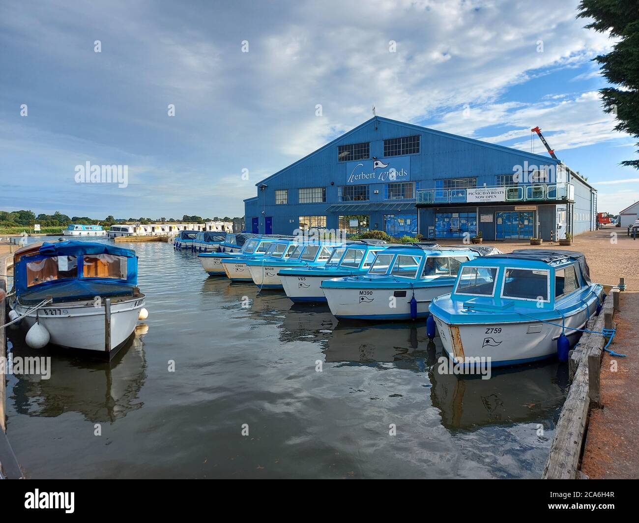 Day boats moored up at Potter Heigham on the Norfolk Broads in from of