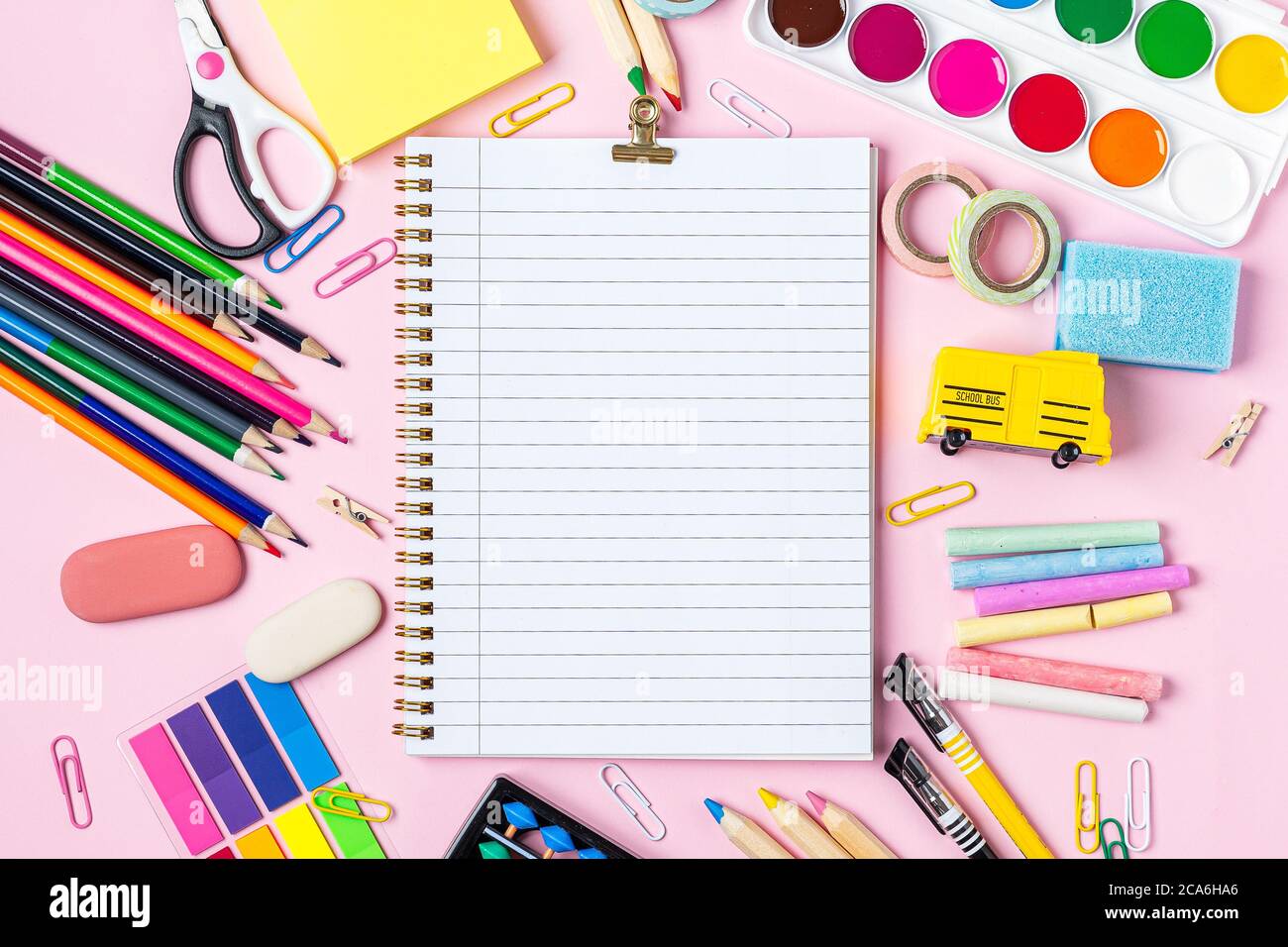 Flat lay of modern pink office desktop with school supplies on table ...
