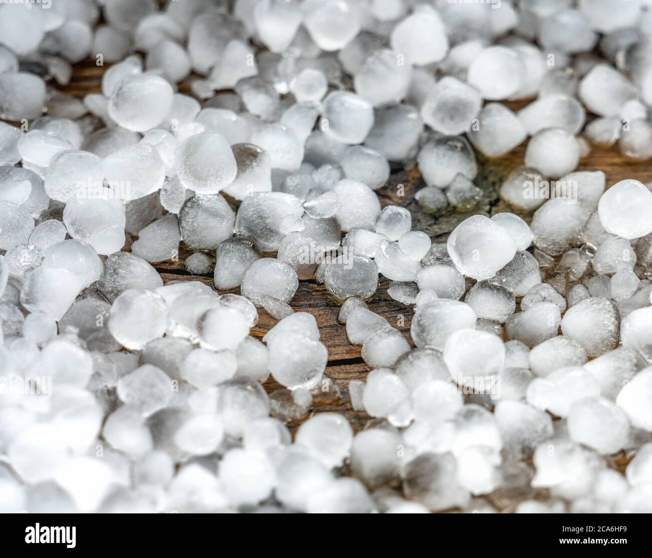 Close up view at hail stones on terrace during hailstorm from sky with sunlight Stock Photo