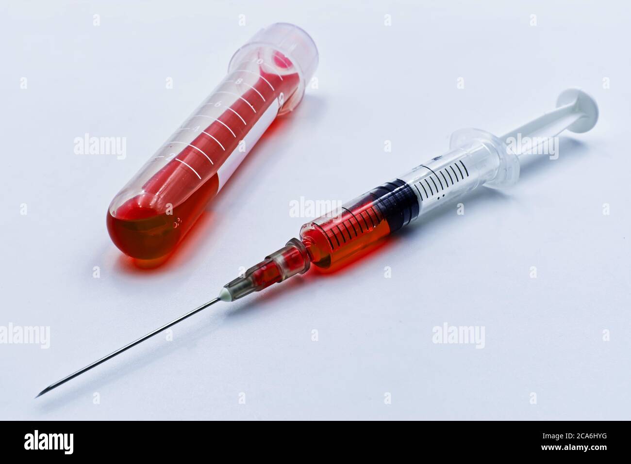 Blood sample and syringe injection, isolated on white background Stock