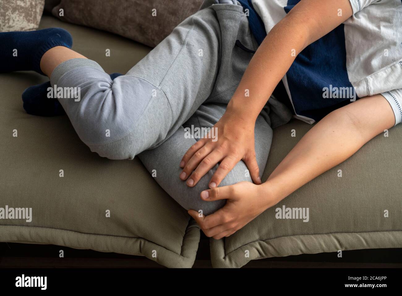 Growth pain in children, boy, 10 years old, has pain in the leg, symbolic image, Stock Photo