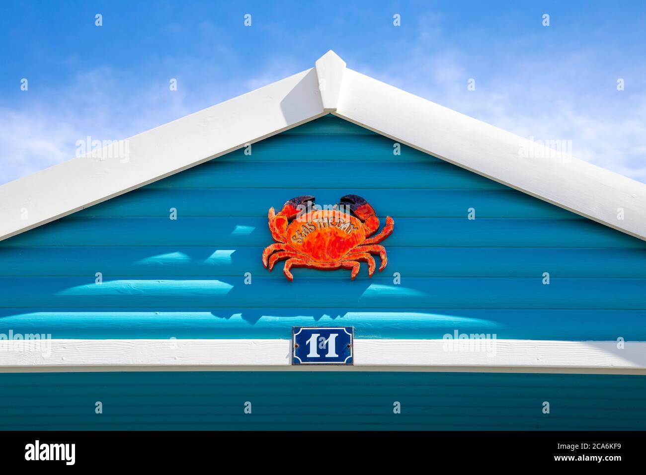Blue exterior of a beach hut with a crab sign 'Seas the day' in West Beach, Whitstable, UK Stock Photo