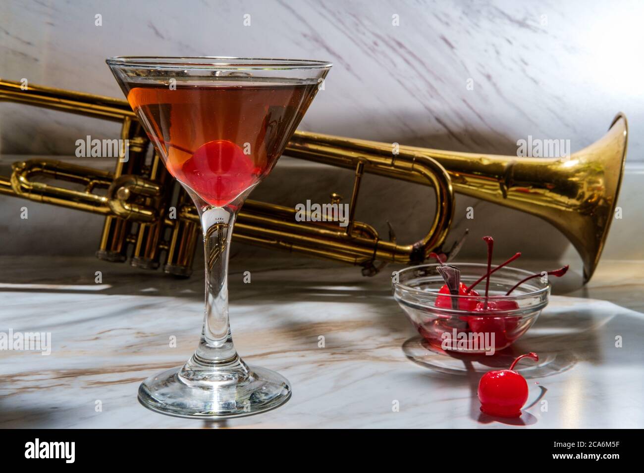 Old fashioned whiskey cocktail with maraschino cherry garnish at Jazz