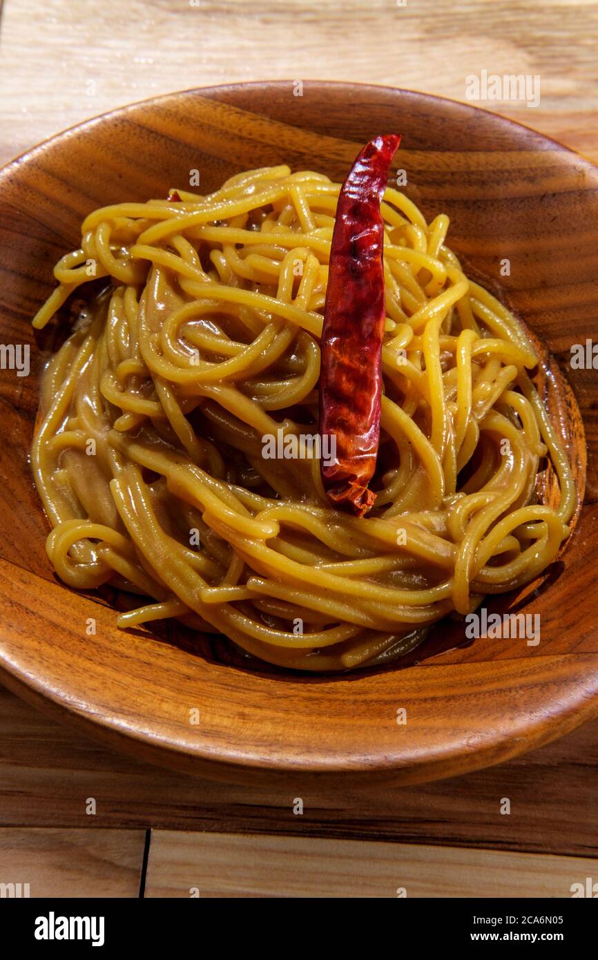 Spicy Thai peanut butter lo mein noodles with dried red pepper Stock