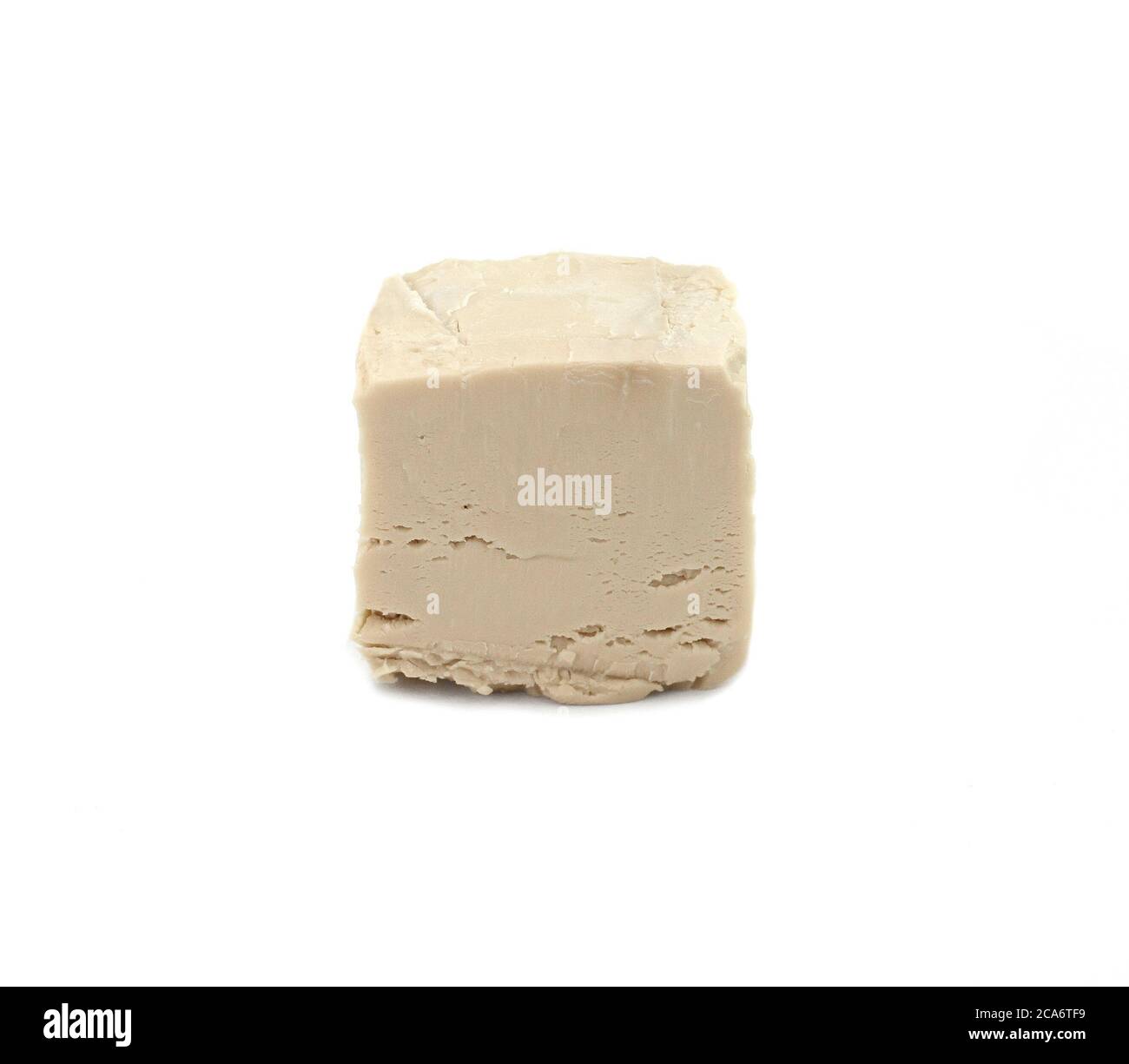 Baker's yeast isolated on white background. A block of compressed fresh