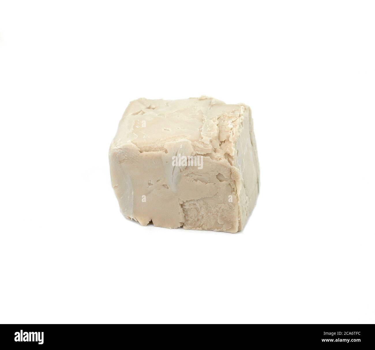 Baker's yeast isolated on white background. A block of compressed fresh