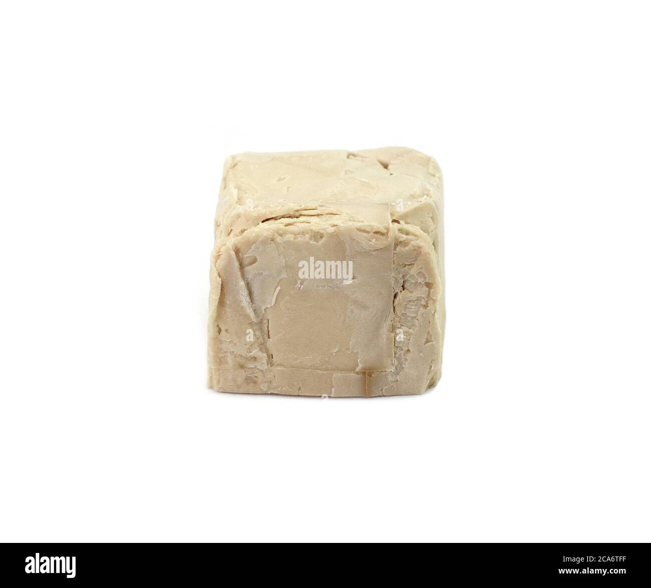 Baker's yeast isolated on white background. A block of compressed fresh