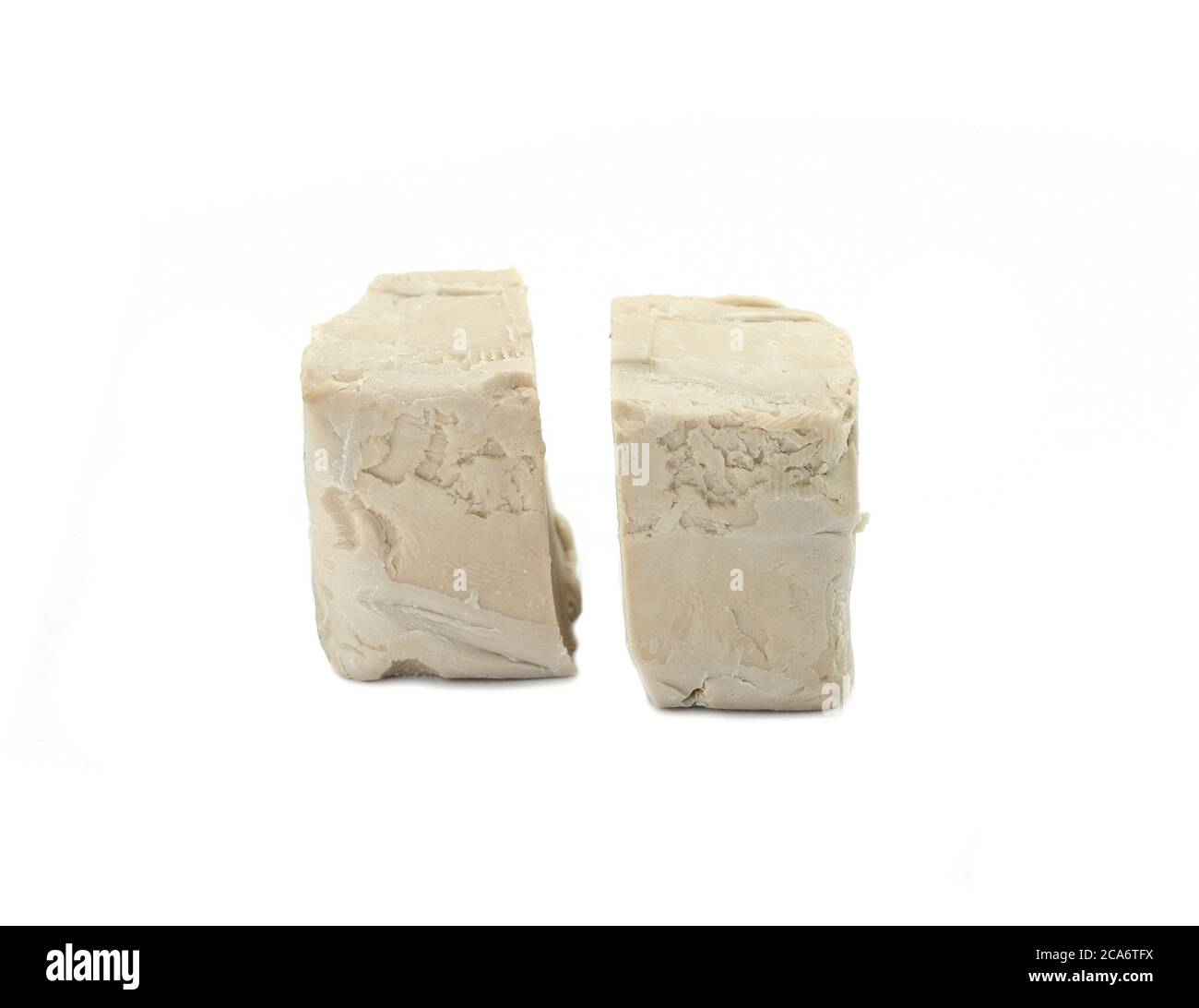 Baker's yeast isolated on white background. A block of compressed fresh