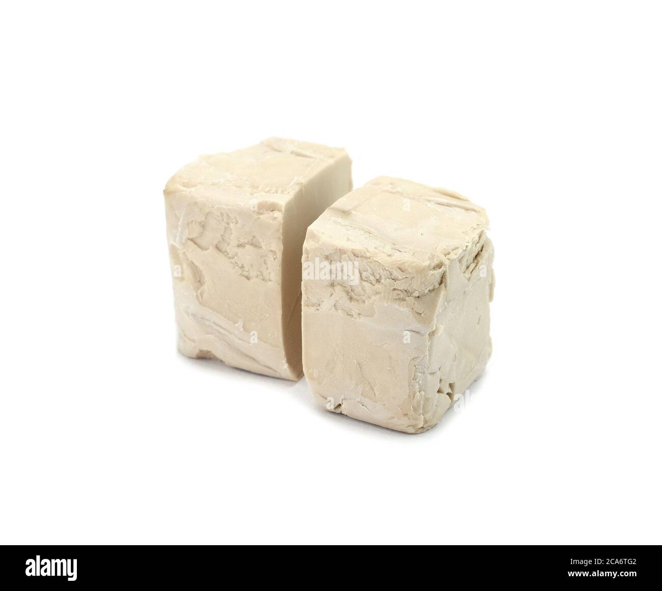 Baker's yeast isolated on white background. A block of compressed fresh