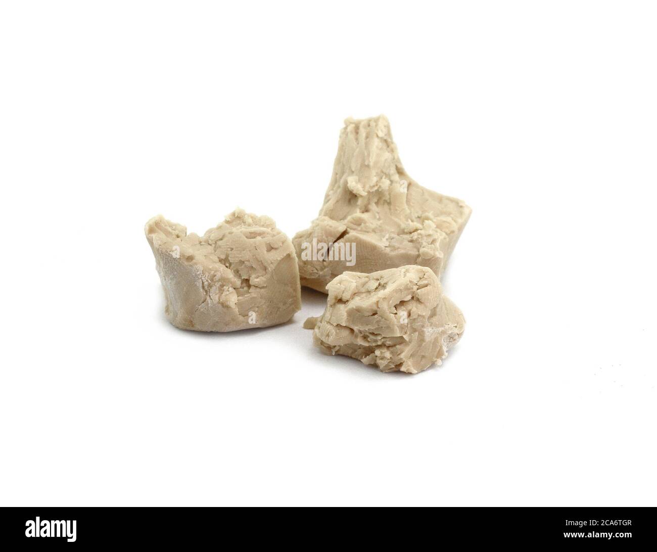 Baker's yeast isolated on white background. A block of compressed fresh