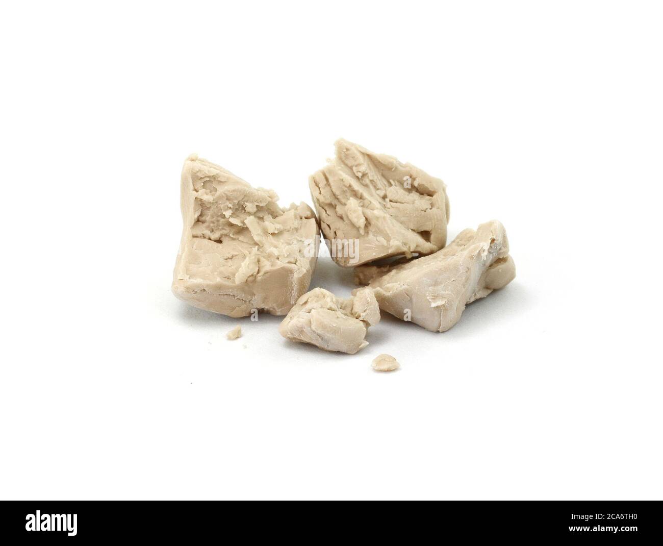 Baker's yeast isolated on white background. A block of compressed fresh