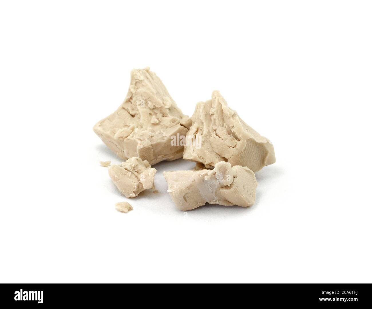 Baker's yeast isolated on white background. A block of compressed fresh